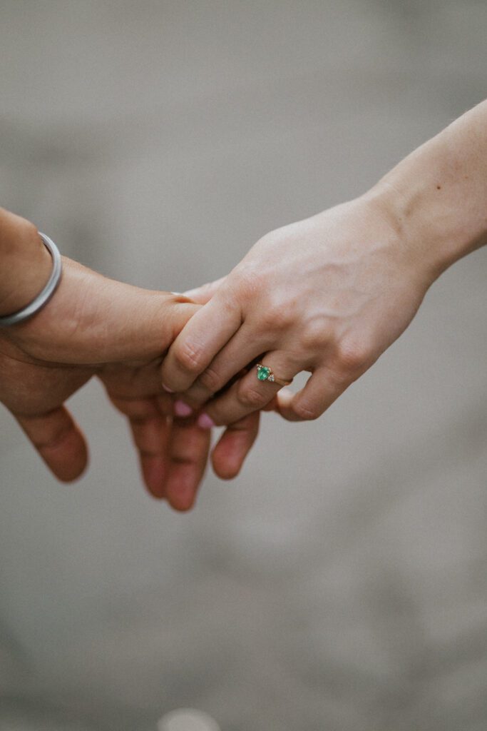we see her engagement ring as they're holding hands