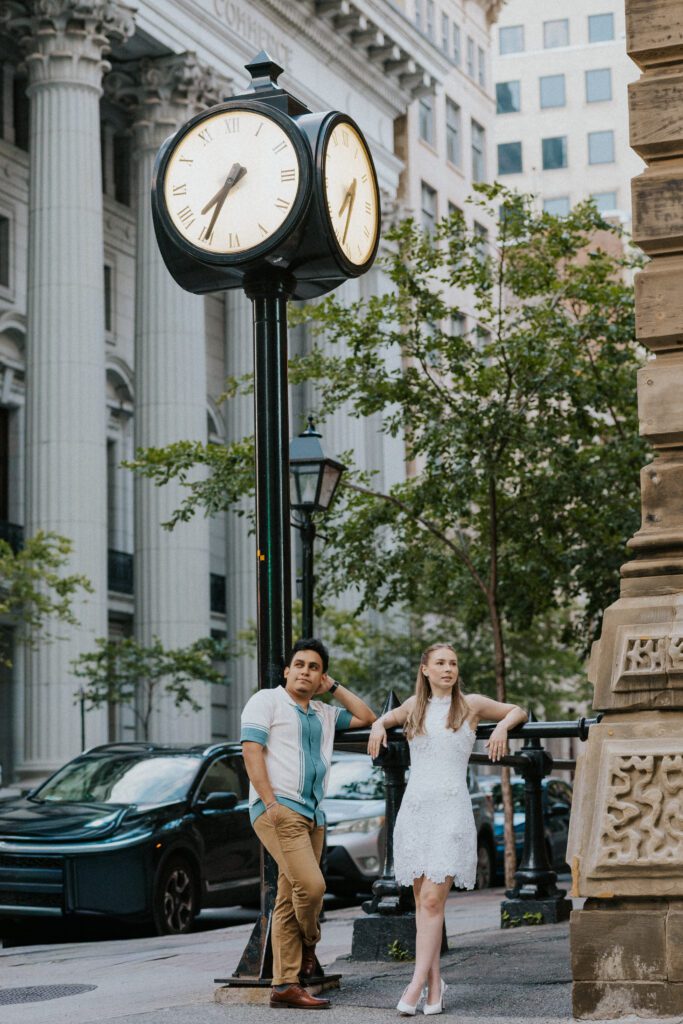 they're standing by a clock in the old montreal