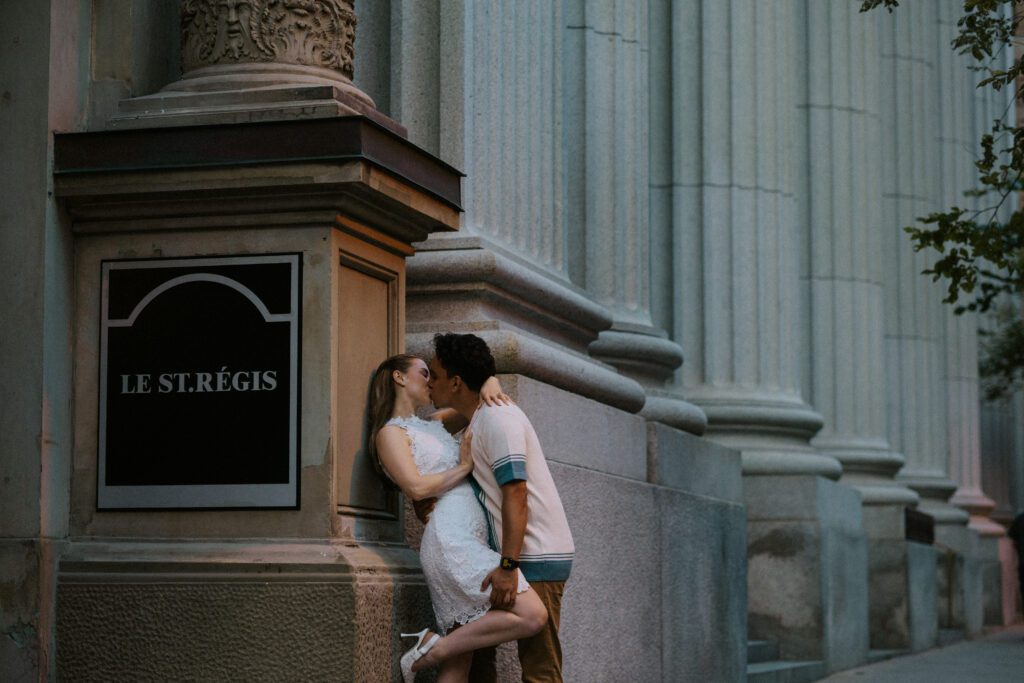 they're kissing by le st régis building in old montreal