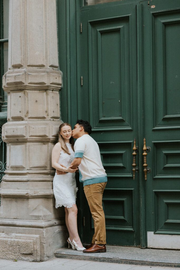 he kisses her on the side of the head during their engagement shoot