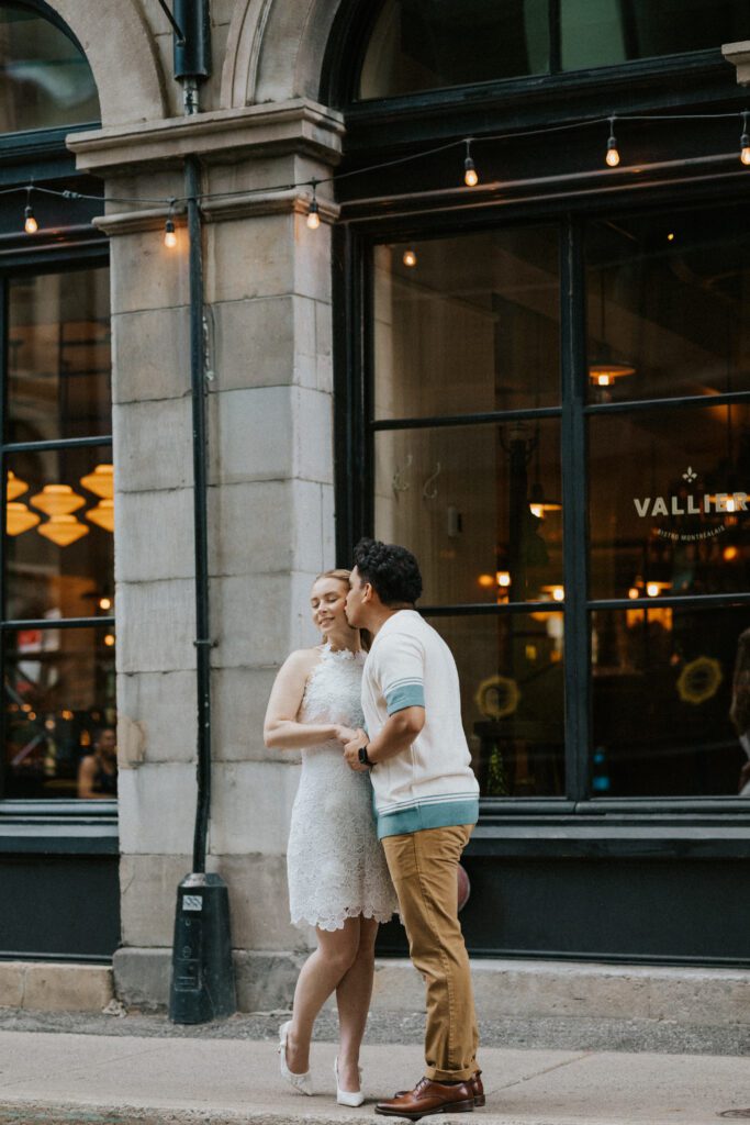 he gives her a loving kiss on the cheek