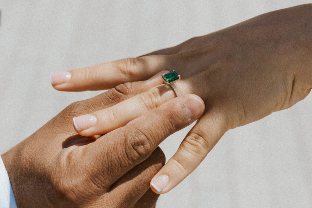 he is putting the ring on her finger