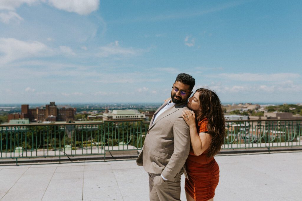 she is kissing his cheek on the balcony of the oratory