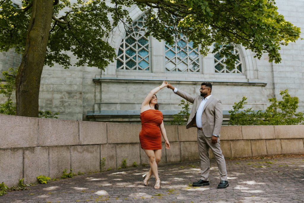 he is making her dance in front of the oratory during their engagement photoshoot